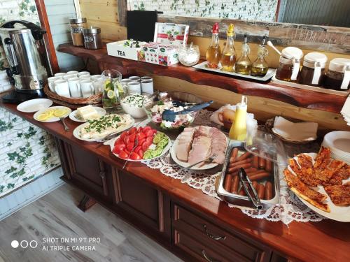 a buffet with many different types of food on a table at Agroturystyka Pod Kołami in Myczkowce