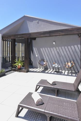 a patio with a table and chairs on a patio at Oporto Lovely House in Porto