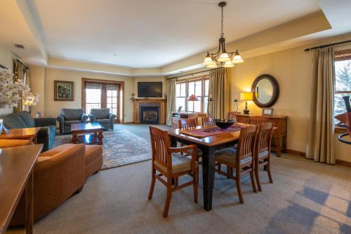 a large living room with a table and chairs at Two Bedroom Condo with Balcony over Mountaineer Square - Just Steps from the Slopes! condo in Crested Butte