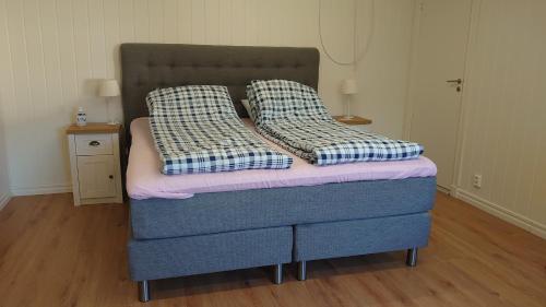 a bed with two pillows on it in a room at Nytorpsgården in Arbrå
