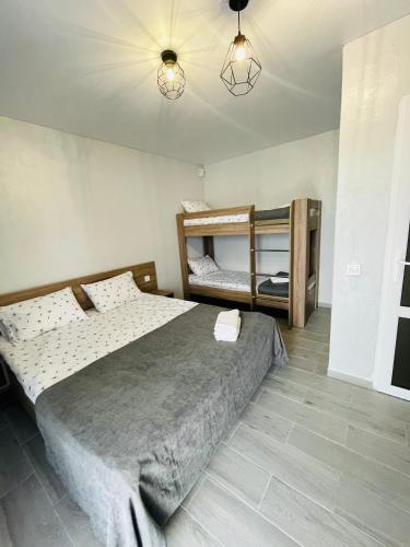 a bedroom with a bed and two bunk beds at GRAFIT in Zatoka
