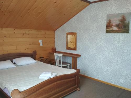 a bedroom with a bed and a desk in a cabin at Zelena Sadyba Bila Stavka in Yaremche