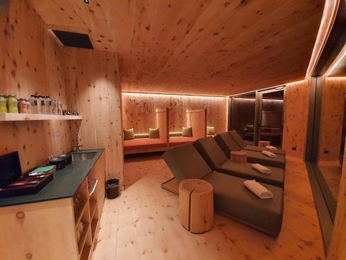 a living room with a couch and a table at Dolomiti Lodge Alverà in Cortina dʼAmpezzo