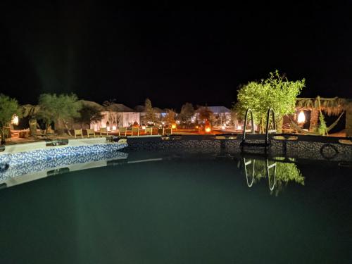 a large body of water surrounded by trees at Sahara Majestic Luxury Camp in Merzouga
