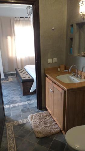 a bathroom with a sink and a mirror at La Casita in Essaouira