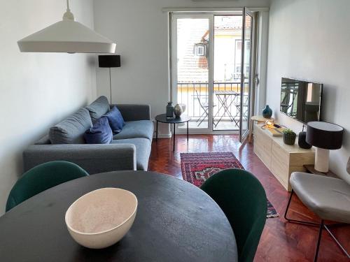 a living room with a couch and a table at Claude Homes Lisbon Rato in Lisbon