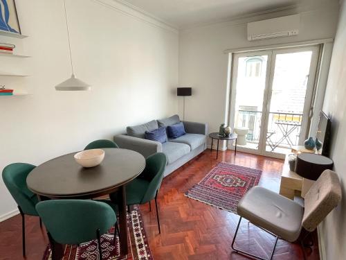 a living room with a table and a couch at Claude Homes Lisbon Rato in Lisbon