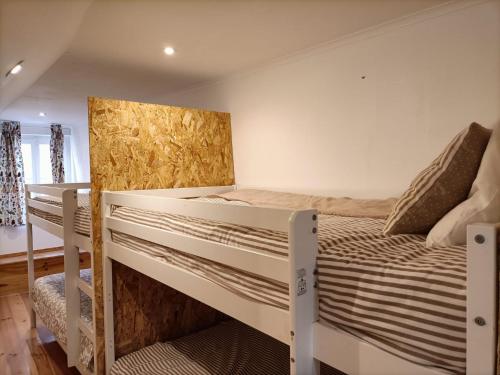 a bedroom with two bunk beds and a desk at NOW Bastidor Jovial in Lisbon