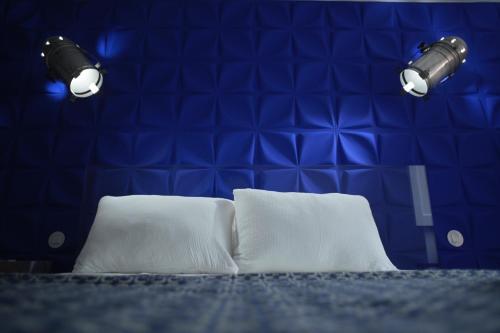 two white pillows in a room with two lights at toctoctoc lisboa in Lisbon