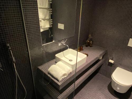 a bathroom with a sink and a toilet at toctoctoc lisboa in Lisbon