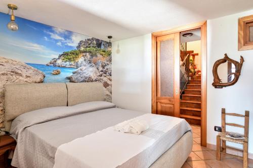 a bedroom with a bed with a painting on the wall at Eleonora's Apartment in Santa Maria Navarrese