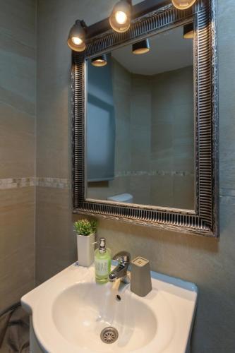 a bathroom with a white sink and a mirror at Apartment 11 - Free Parking in Zlatibor