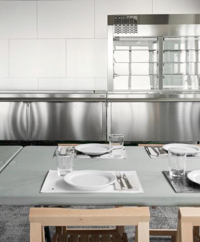 a kitchen with a table with plates and glasses on it at Abrigall Hostel Masella in La Masella