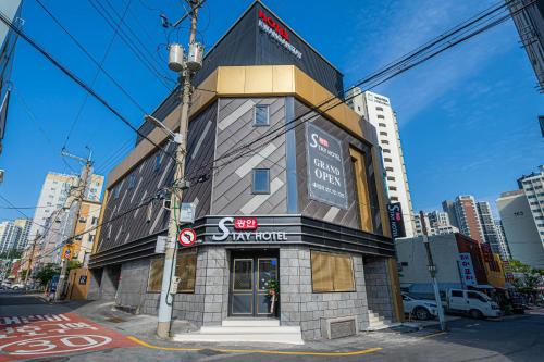 a building on the corner of a city street at Gwangan Stay Hotel in Busan