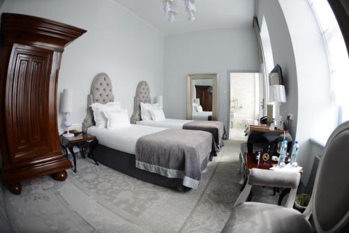 a bedroom with two beds and a large mirror at Hotel Krasicki in Lidzbark Warmiński