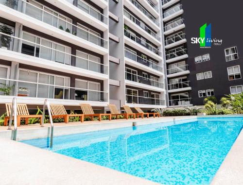a swimming pool in front of a building at Skyliving Towers Apartments - Perú in Lima