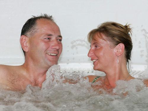 a man and a woman sitting in a bathtub at 6 person holiday home in Skærbæk-By Traum in Skærbæk