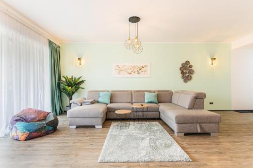 a living room with a couch and a rug at Fabulous Panorama Silver Mountain Apartments in Poiana Brasov