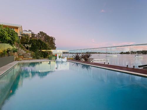 a large pool of blue water with a view of a river at Absolute Waterfront Lakehouse Fishing Point Waterfront Pool Jetty in Fishing Point