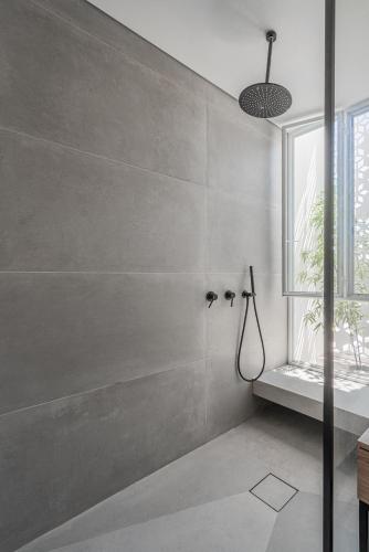 a bathroom with a shower and a window at Danielle boutique suite in Caesarea