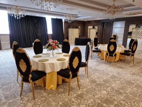a meeting room with a table and chairs with flowers at Hotel CASA Aishbagh in Lucknow