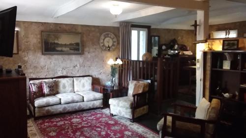 a living room with a couch and a chair at A La Folly The Retreat in Murray Bridge