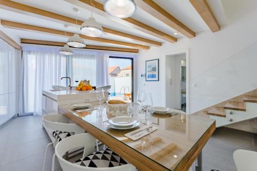 a kitchen with a dining table and a staircase at Villa Stone Pearl in Sutivan