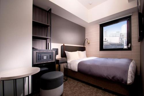 Ένα ή περισσότερα κρεβάτια σε δωμάτιο στο Joytel Hotel Namba Dotonbori
