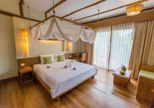 Postel nebo postele na pokoji v ubytování Metadee Concept Hotel