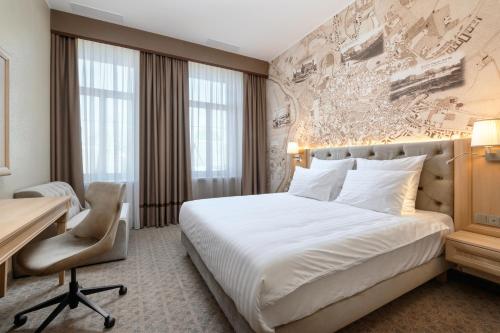 a hotel room with a bed and a desk at CALVARY Hotel & Restaurant Vilnius in Vilnius