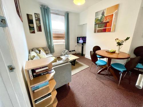a living room with a couch and a table at 4 bedroomed maisonette in City Centre, near Barbican & Seafront in Plymouth