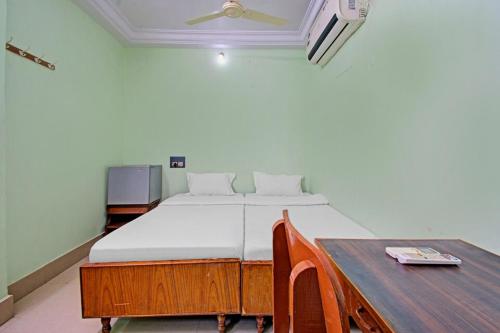 a bed in a room with a table and a bed sidx sidx sidx at Decent residency in Kākināda