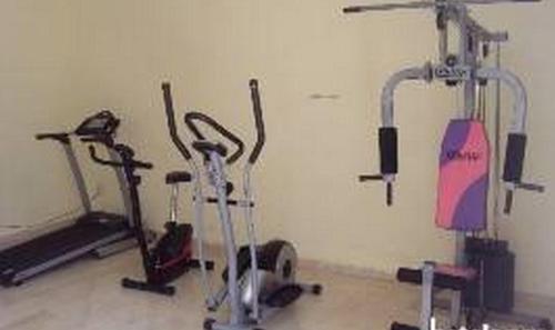 a gym with three exercise bikes in a room at Ade Super Hotel Single in Akure