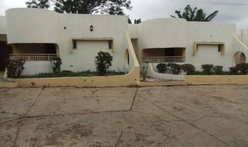 a large white building with a lot of windows at Ade Super Hotel Single in Akure