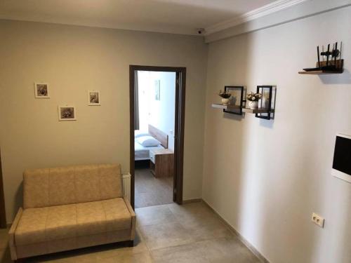 a living room with a couch and a door to a bedroom at Chaki Hotel in Ureki
