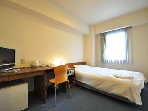 Säng eller sängar i ett rum på Hotel Koshien