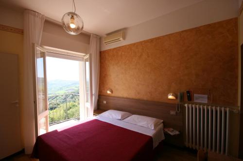 A bed or beds in a room at Albergo Centopini
