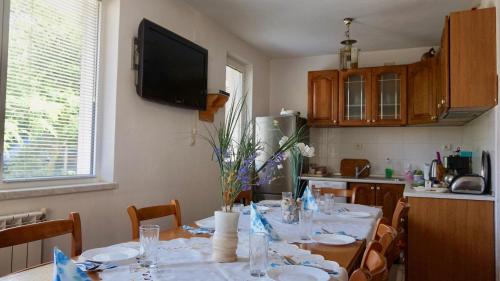 a dining room with a table with white dishes on it at Pamir Guest House in Shipkovo