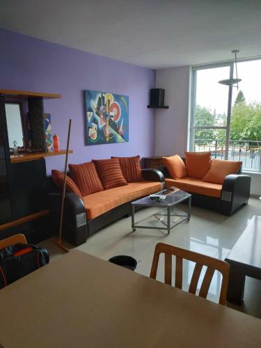 a living room with a couch and a table at Marshov Rehovot - Apartment in center of Rehovot near shopping mall and Weizmann Institute in Rechovot
