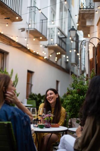 a group of people sitting at a table in a restaurant at La Sacristía in Tarifa