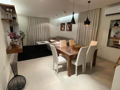 a dining room and living room with a table and chairs at Deluxe Apartment with pool in the heart of St Pauls Bay in St Paul's Bay