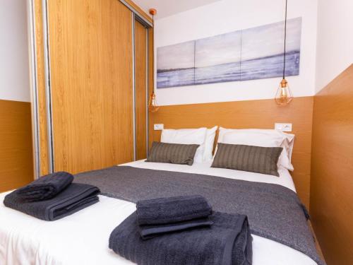 two beds in a room with towels on them at Cherry Friendly Holiday Home in Playa del Ingles