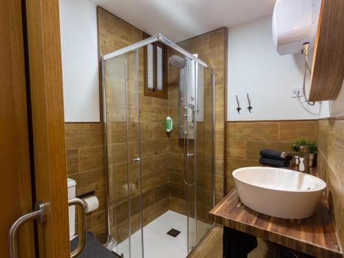a bathroom with a glass shower and a sink at Cherry Friendly Holiday Home in Playa del Ingles
