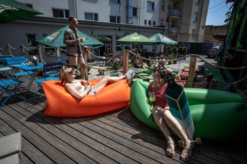 two girls are riding on inflatables at a water park at Kampus Palace in Ostrava