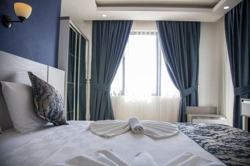 Postel nebo postele na pokoji v ubytování Demyra Boutique Hotel