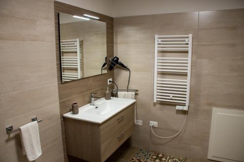 a bathroom with a sink and a mirror at La Dimora del Viaggiatore Luxury Apartments in Mazara del Vallo