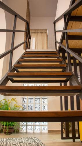 a staircase in a house with wooden treads at La Dimora del Viaggiatore Luxury Apartments in Mazara del Vallo