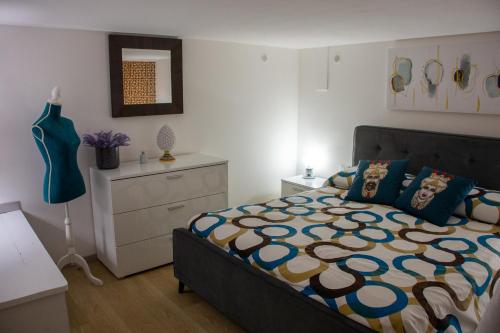 a bedroom with a bed and a dresser at La Dimora del Viaggiatore Luxury Apartments in Mazara del Vallo