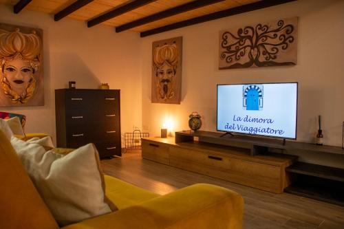 a living room with a flat screen tv at La Dimora del Viaggiatore Luxury Apartments in Mazara del Vallo