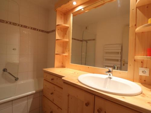 uma casa de banho com um lavatório, um espelho e uma banheira em Appartement Méribel, 2 pièces, 4 personnes - FR-1-182-7 em Méribel